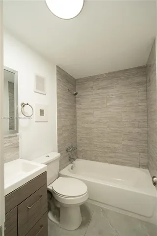 a bathroom with a toilet a sink and bathtub