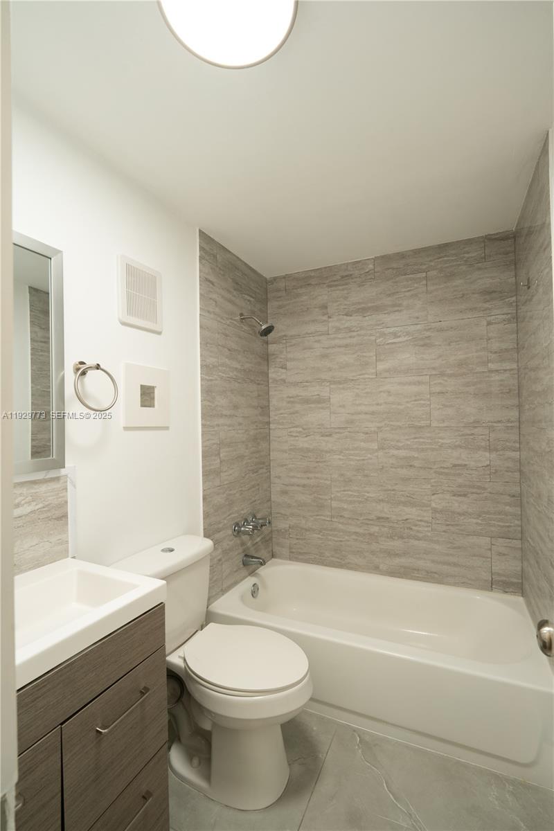 6725 Northwest 192nd Lane Hialeah, FL 33015 - Photo 10 of 29 a bathroom with a toilet a sink and bathtub