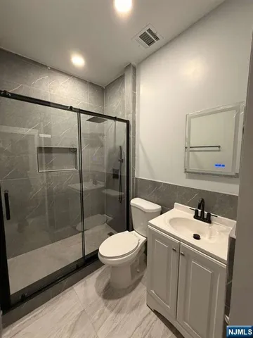 a bathroom with a toilet a sink and a shower