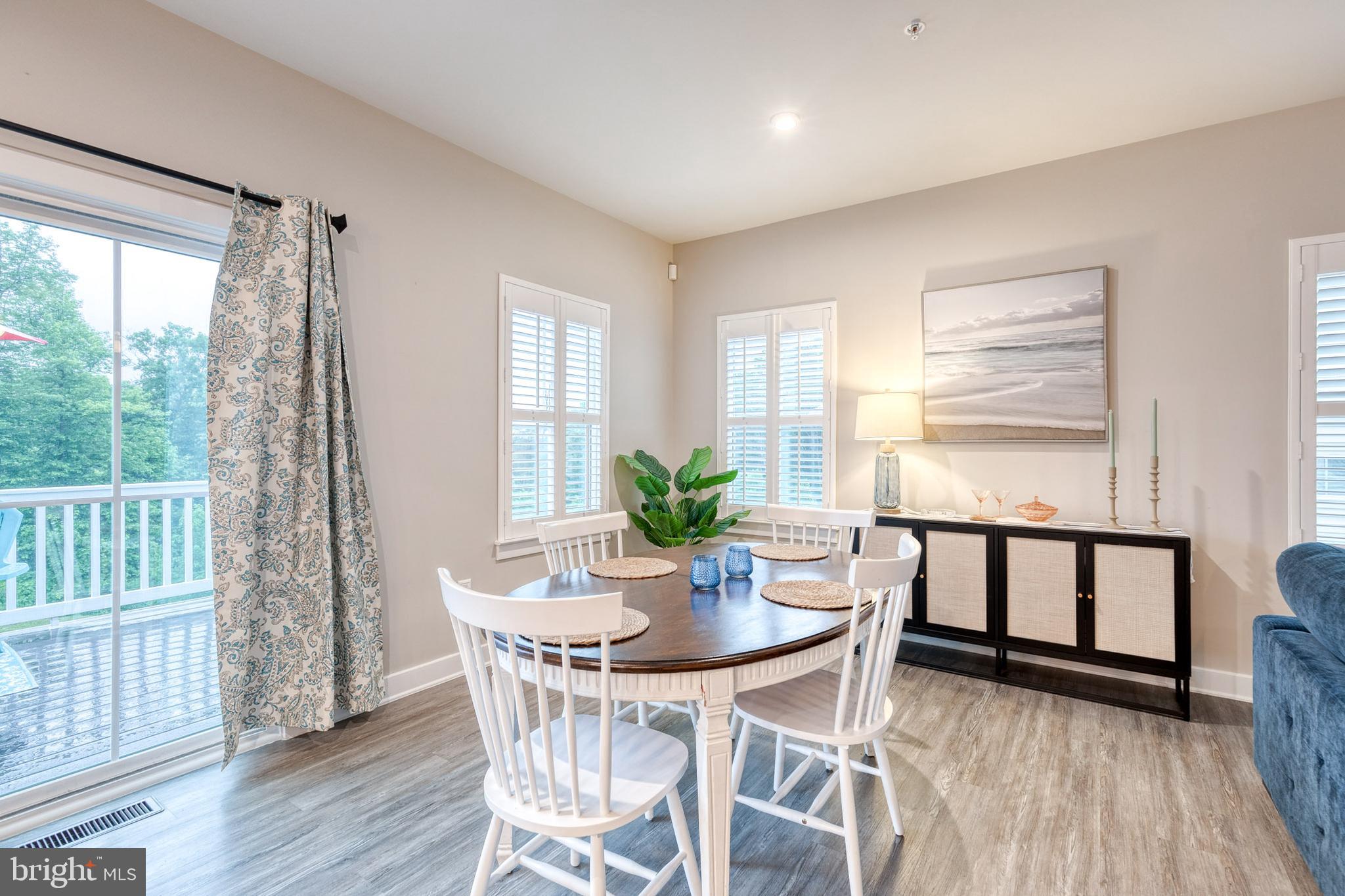 6003 Valentine Way Hanover, MD 21076 - Photo 11 of 52 a view of a dining room with furniture window and wooden floor