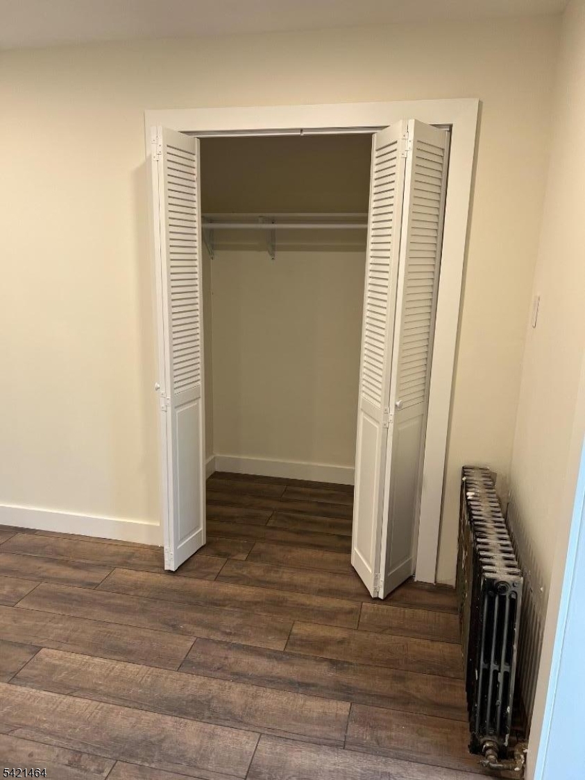 227 Palmer Street, Unit 2 Elizabeth, NJ 07202 - Photo 11 of 13 an empty room with wooden floor and a window