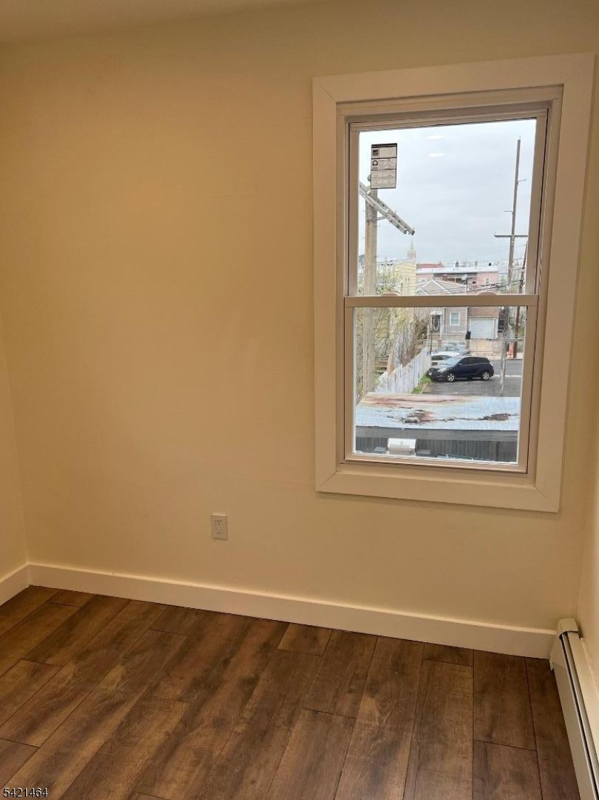 227 Palmer Street, Unit 2 Elizabeth, NJ 07202 - Photo 4 of 13 a view of a small space with wooden floor and a window
