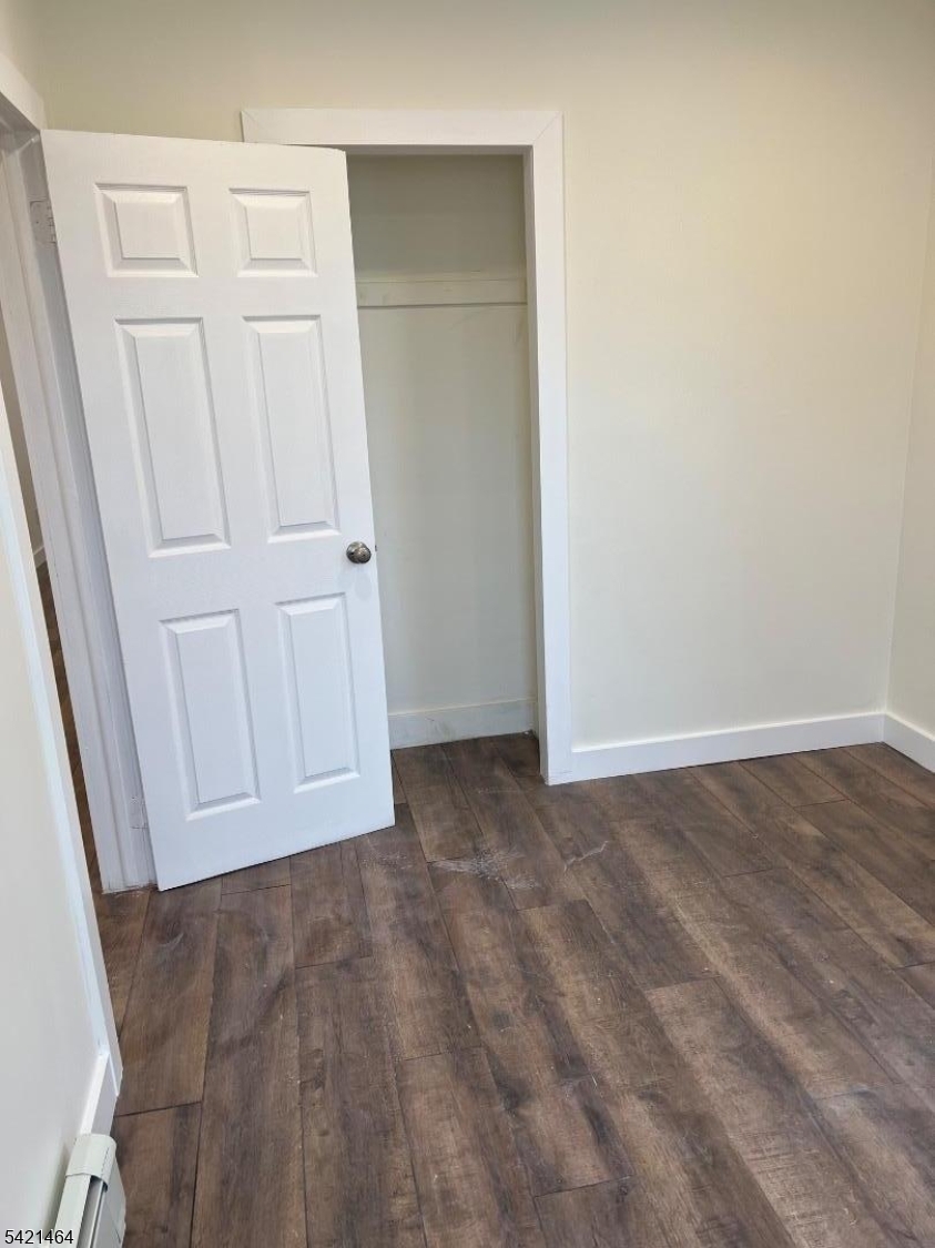 227 Palmer Street, Unit 2 Elizabeth, NJ 07202 - Photo 6 of 13 an empty room with a wooden door