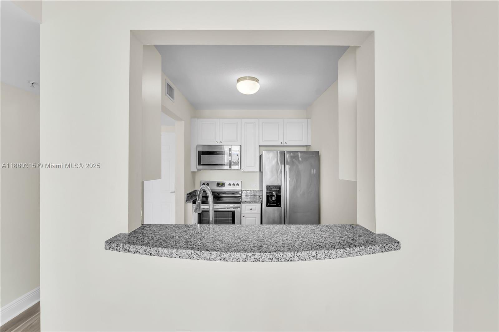 900 Southwest 8th Street, Unit 1110 Miami, FL 33130 - Photo 13 of 27 a view of kitchen with stainless steel appliances granite countertop refrigerator sink and stove