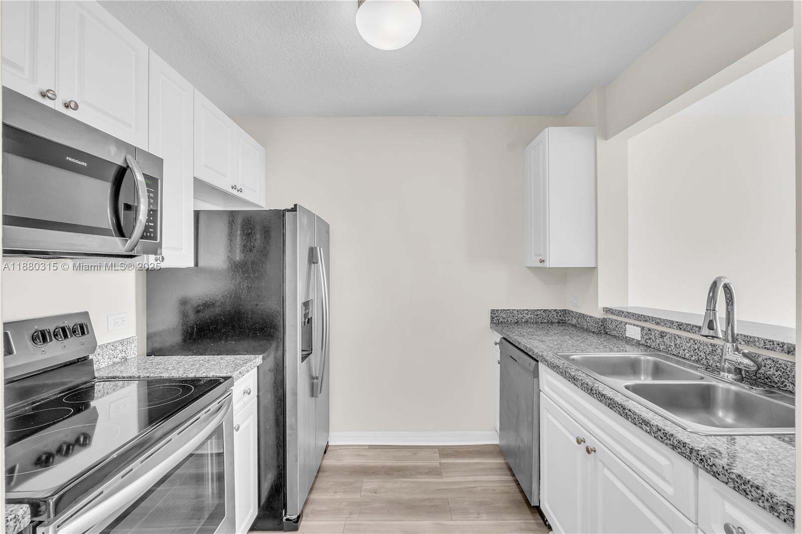 900 Southwest 8th Street, Unit 1110 Miami, FL 33130 - Photo 14 of 27 a kitchen with stainless steel appliances granite countertop a sink stove and refrigerator
