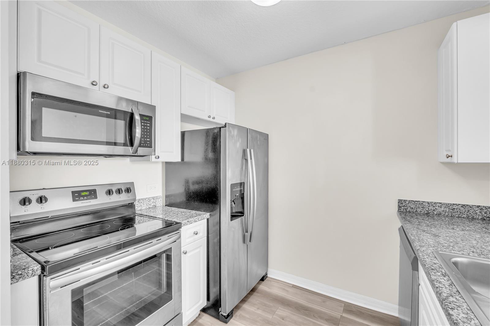 900 Southwest 8th Street, Unit 1110 Miami, FL 33130 - Photo 16 of 27 a kitchen with a stove microwave and refrigerator