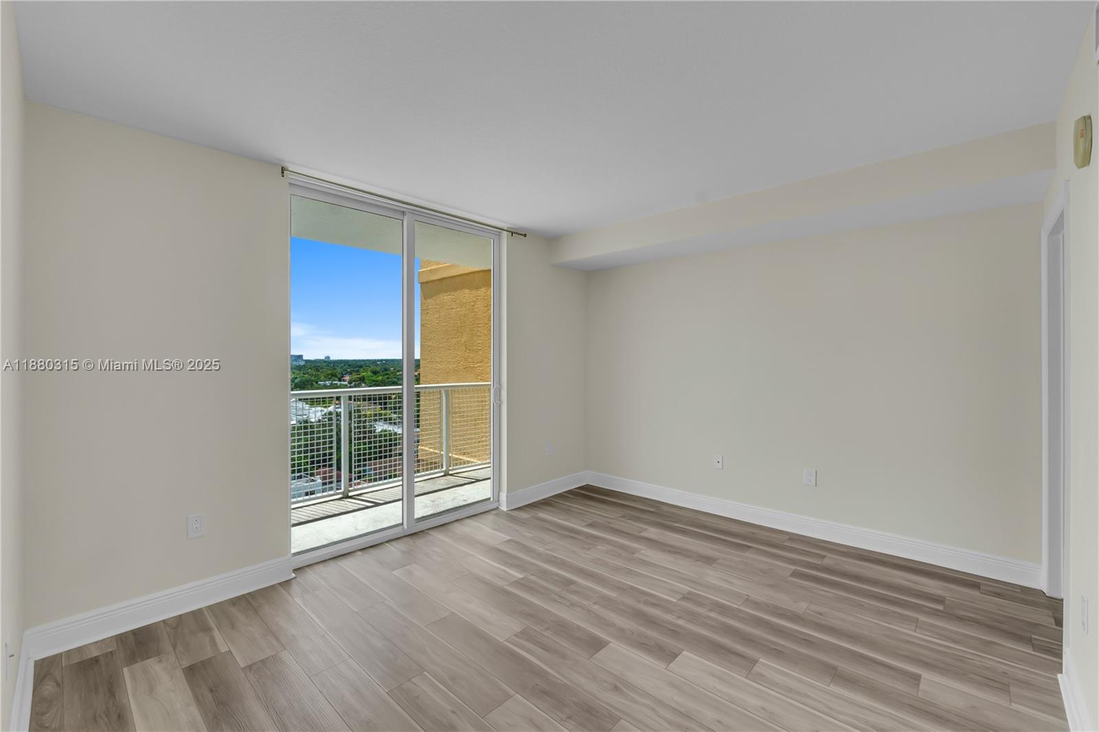 900 Southwest 8th Street, Unit 1110 Miami, FL 33130 - Photo 18 of 27 wooden floor in an empty room with a window