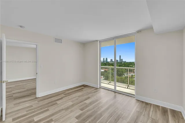 a view of hallway with wooden floor