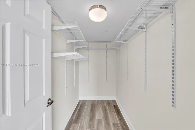 a view of a room with wooden floor