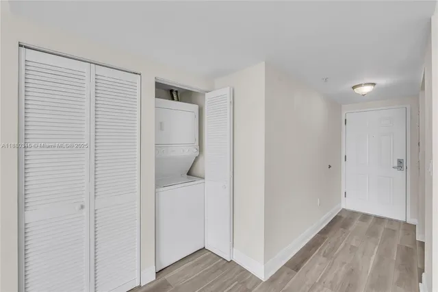 a front view of multi story residential apartment building with yard and parking space