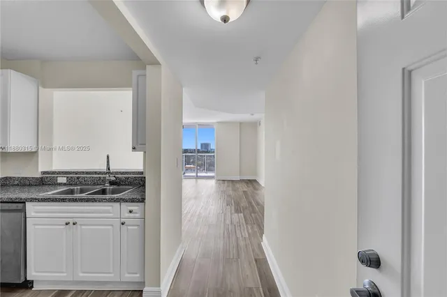 a view of empty room with wooden floor