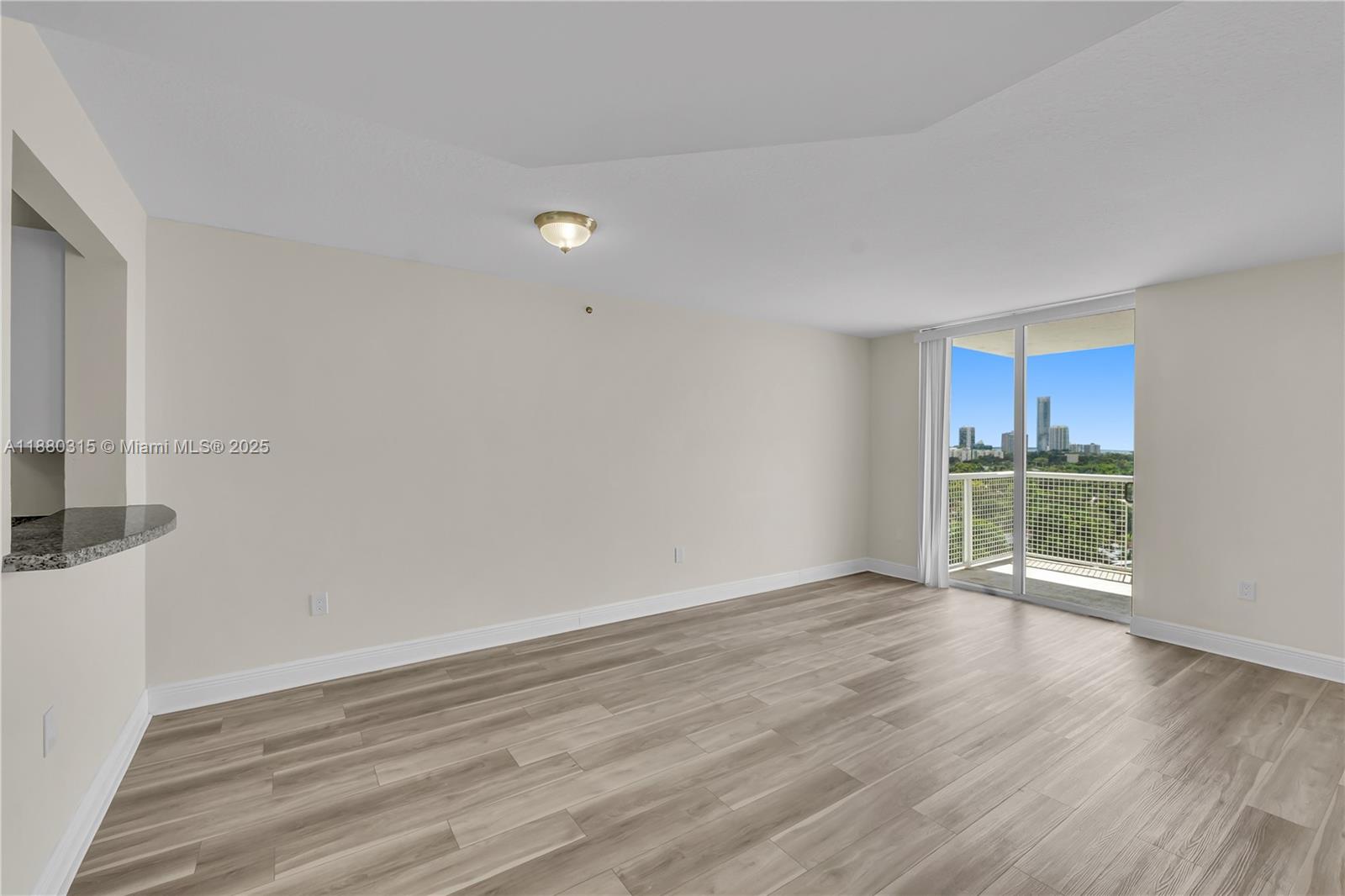 900 Southwest 8th Street, Unit 1110 Miami, FL 33130 - Photo 10 of 27 a view of an empty room with wooden floor and a window