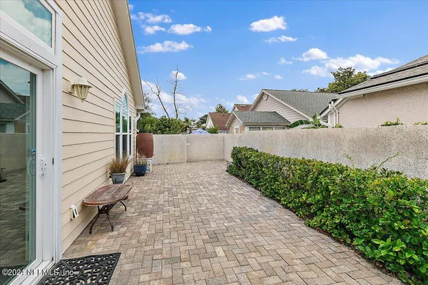 a backyard of a house with yard and outdoor seating
