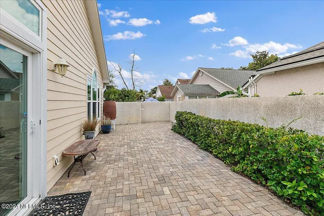 a backyard of a house with yard and outdoor seating