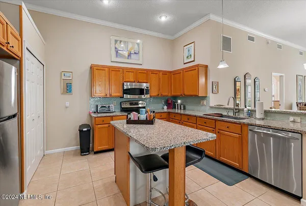 a living room with furniture a fireplace and a chandelier