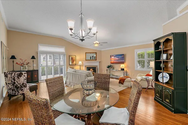 a spacious bedroom with a bed and wooden floor