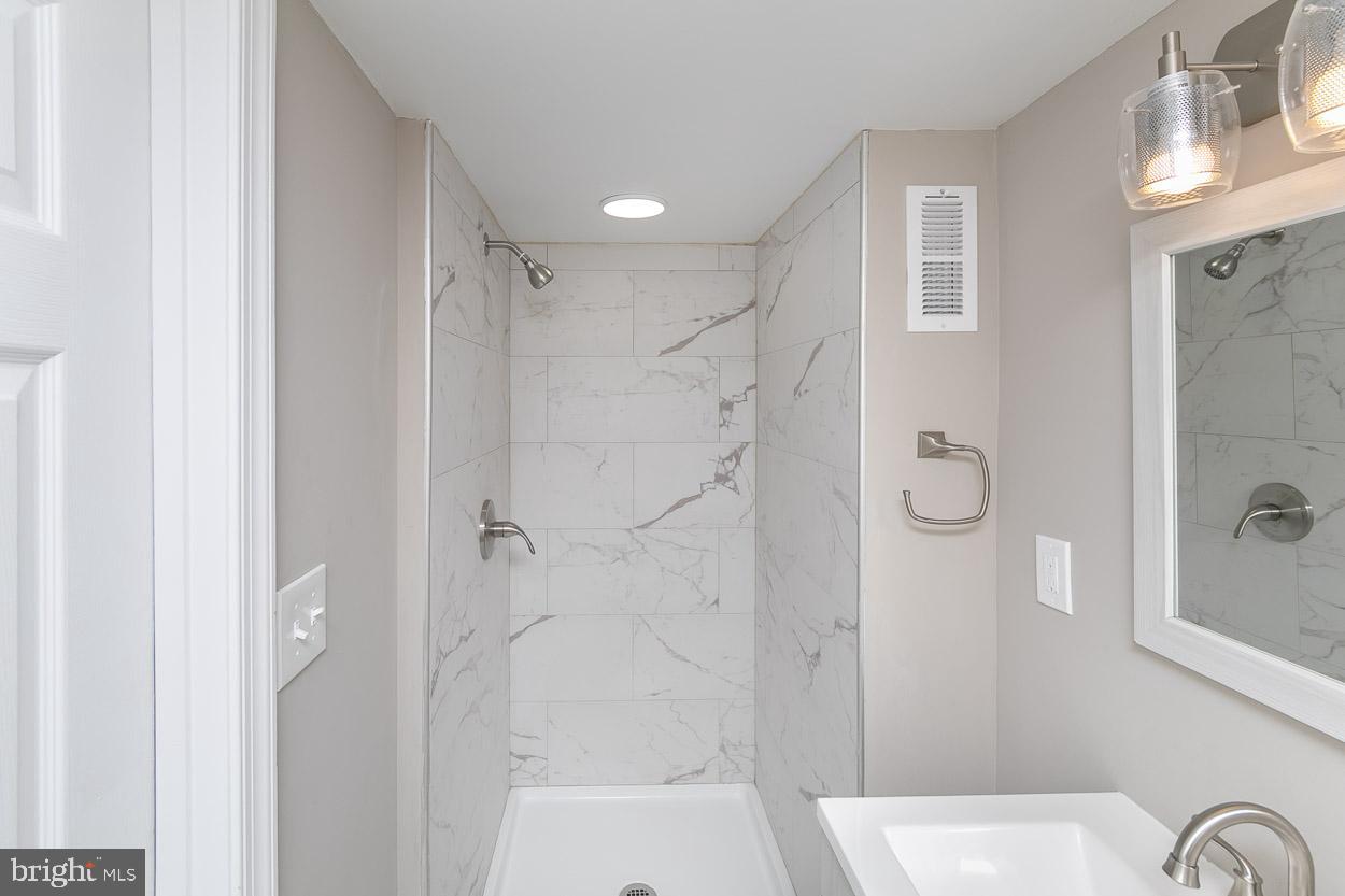 404 Upland Road Pikesville, MD 21208 - Photo 31 of 34 Remodeled Full Bath with custom tile & paint.