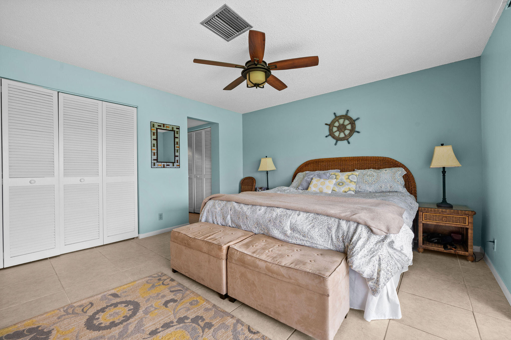 355 Palm Drive, Unit 2 Naples, FL 34112 - Photo 12 of 30 a bedroom with a bed and a chandelier