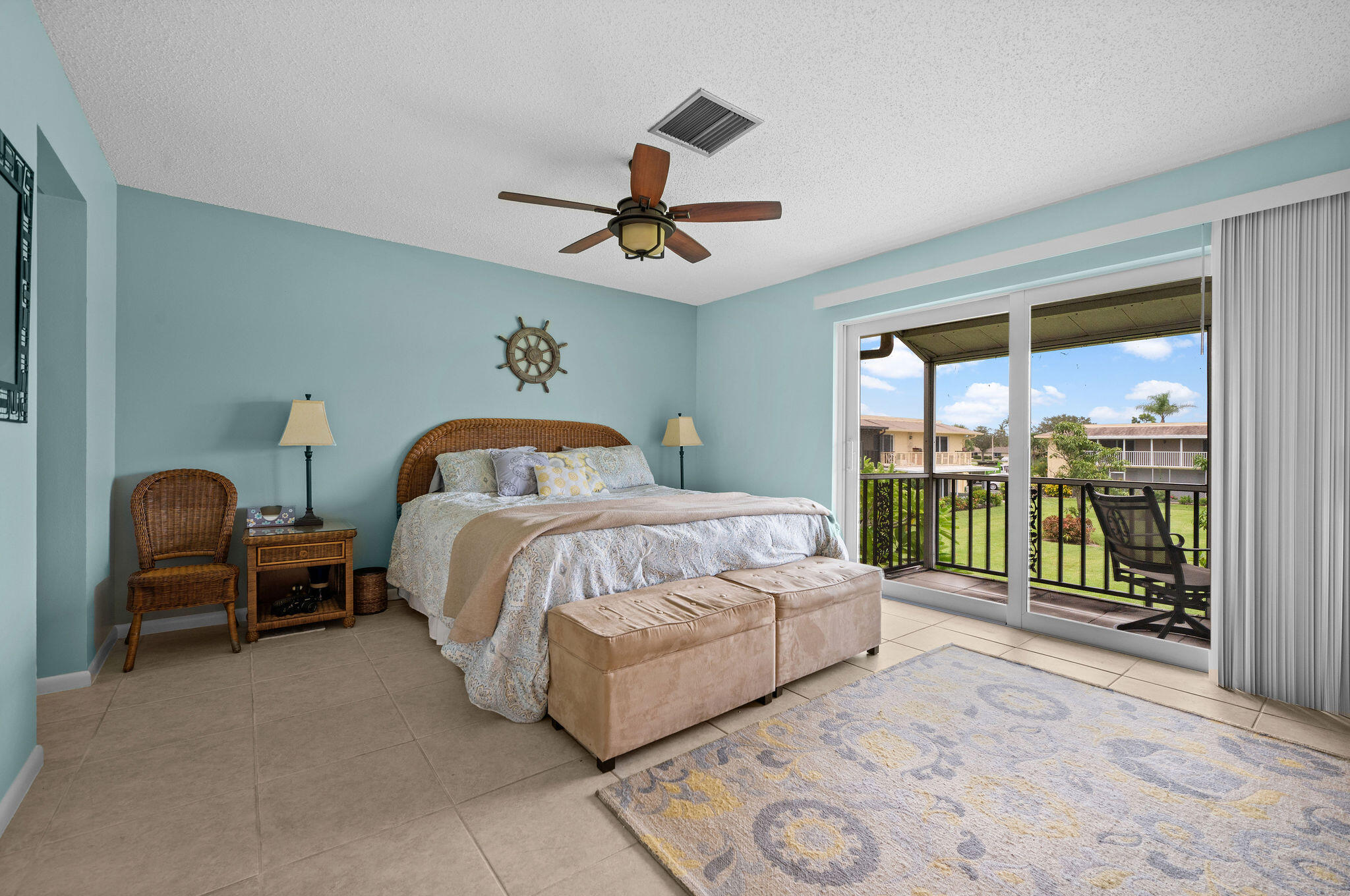355 Palm Drive, Unit 2 Naples, FL 34112 - Photo 13 of 30 a spacious bedroom with a bed and large windows