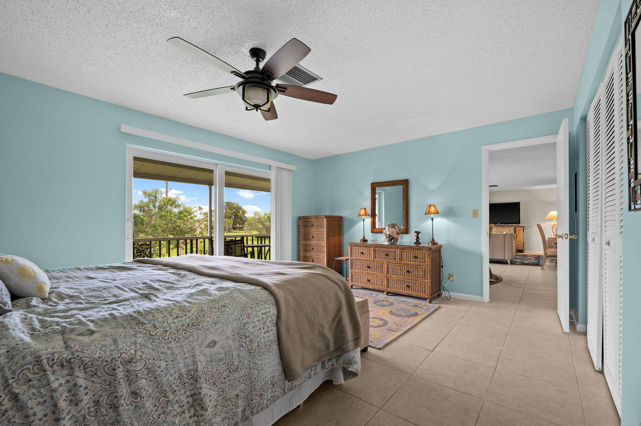 355 Palm Drive, Unit 2 Naples, FL 34112 - Photo 14 of 30 a bedroom with a large bed and a chandelier