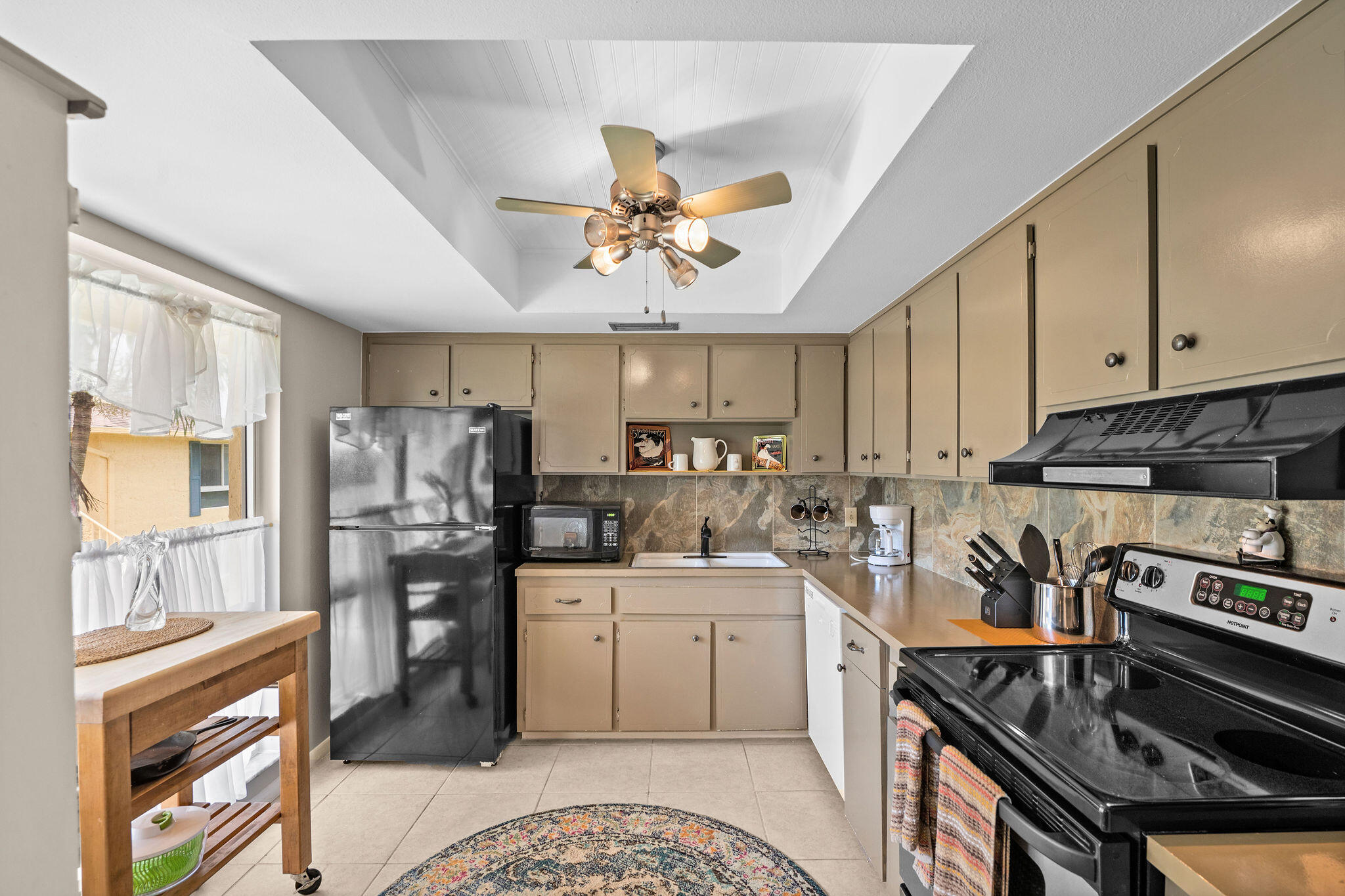 355 Palm Drive, Unit 2 Naples, FL 34112 - Photo 18 of 30 a kitchen with a sink appliances cabinets and a window