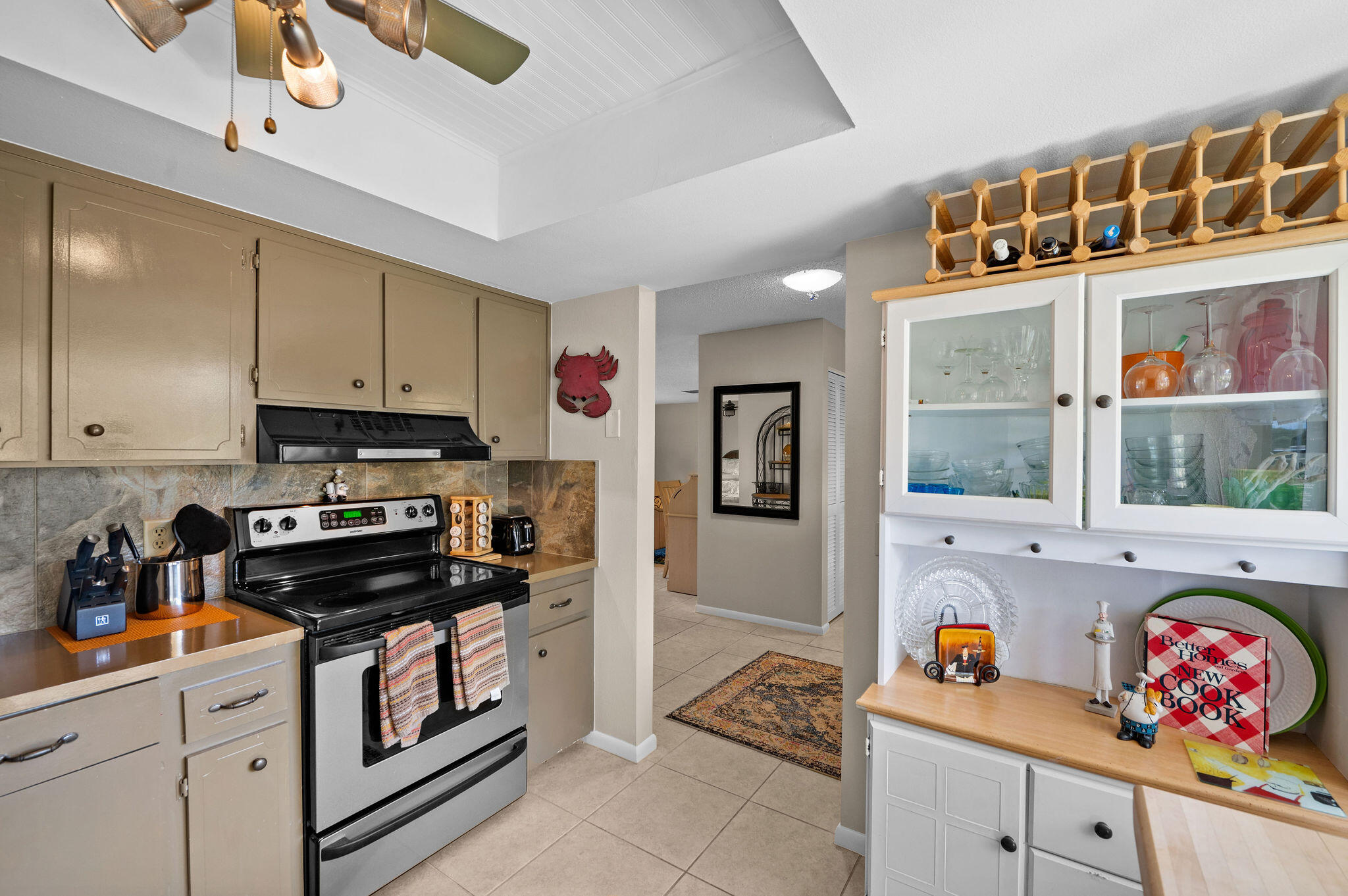 355 Palm Drive, Unit 2 Naples, FL 34112 - Photo 19 of 30 a kitchen with stainless steel appliances a stove a sink and a microwave