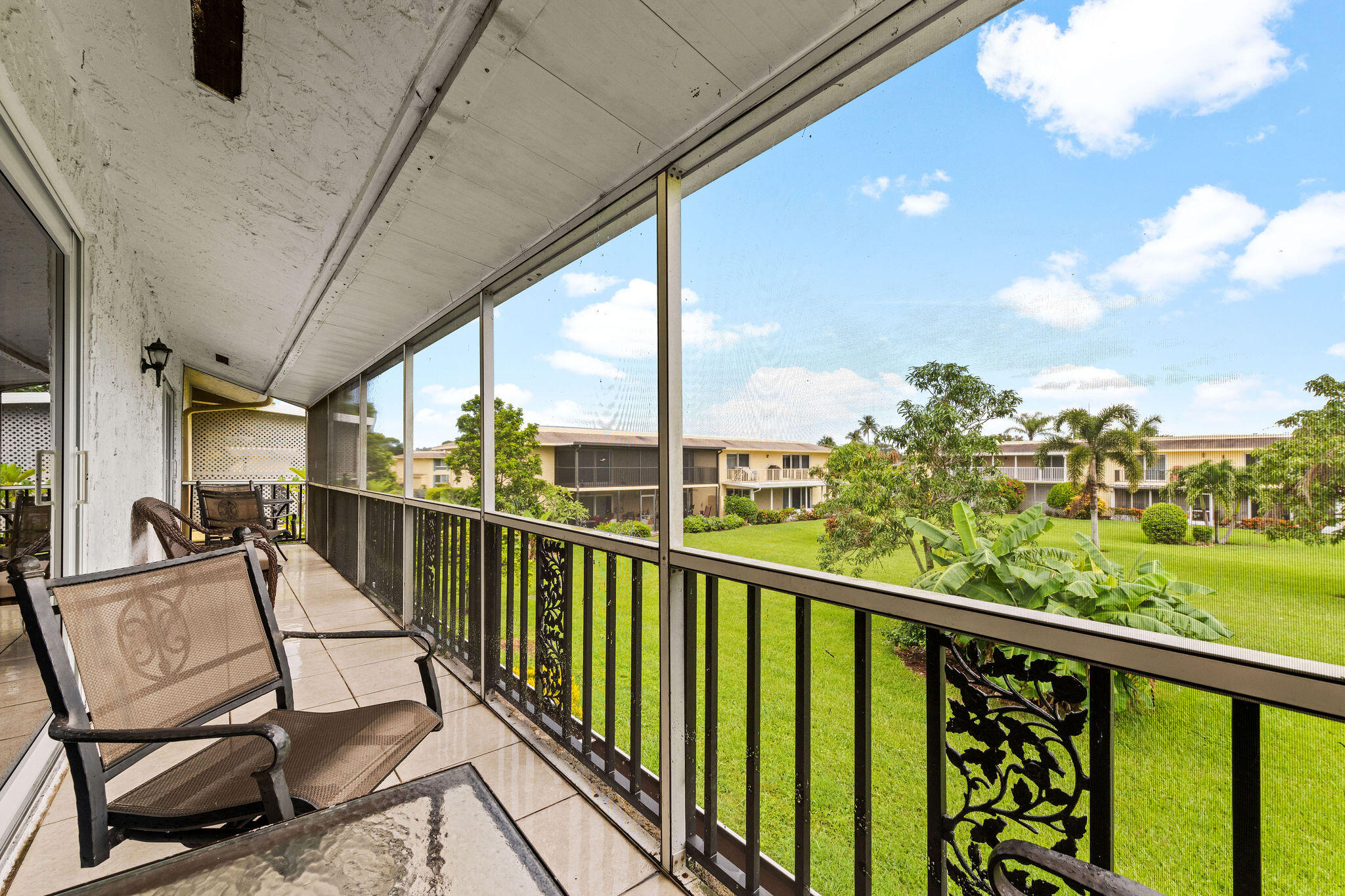 355 Palm Drive, Unit 2 Naples, FL 34112 - Photo 22 of 30 a view of a chairs and table in balcony