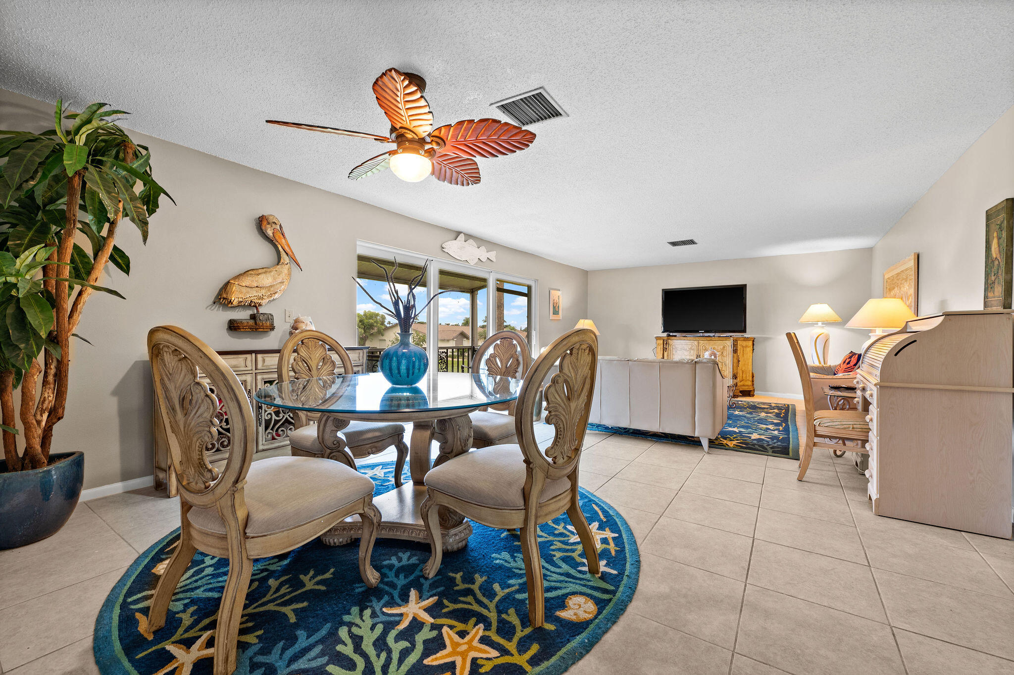 355 Palm Drive, Unit 2 Naples, FL 34112 - Photo 5 of 30 a dining room with furniture a rug and a chandelier
