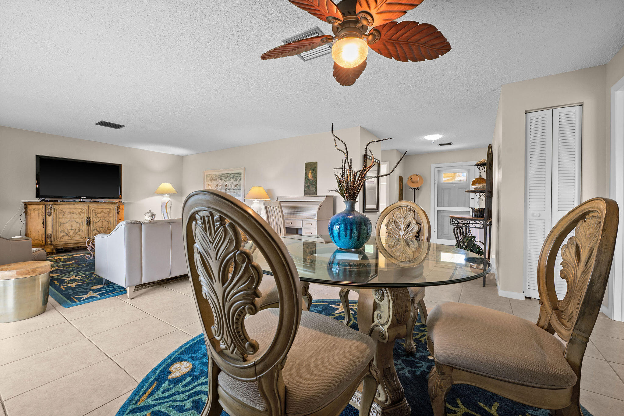 355 Palm Drive, Unit 2 Naples, FL 34112 - Photo 7 of 30 a view of a dining room with furniture and chandelier