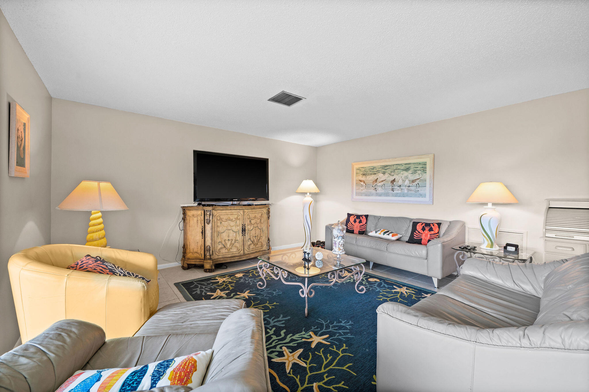 355 Palm Drive, Unit 2 Naples, FL 34112 - Photo 8 of 30 a living room with furniture and a flat screen tv