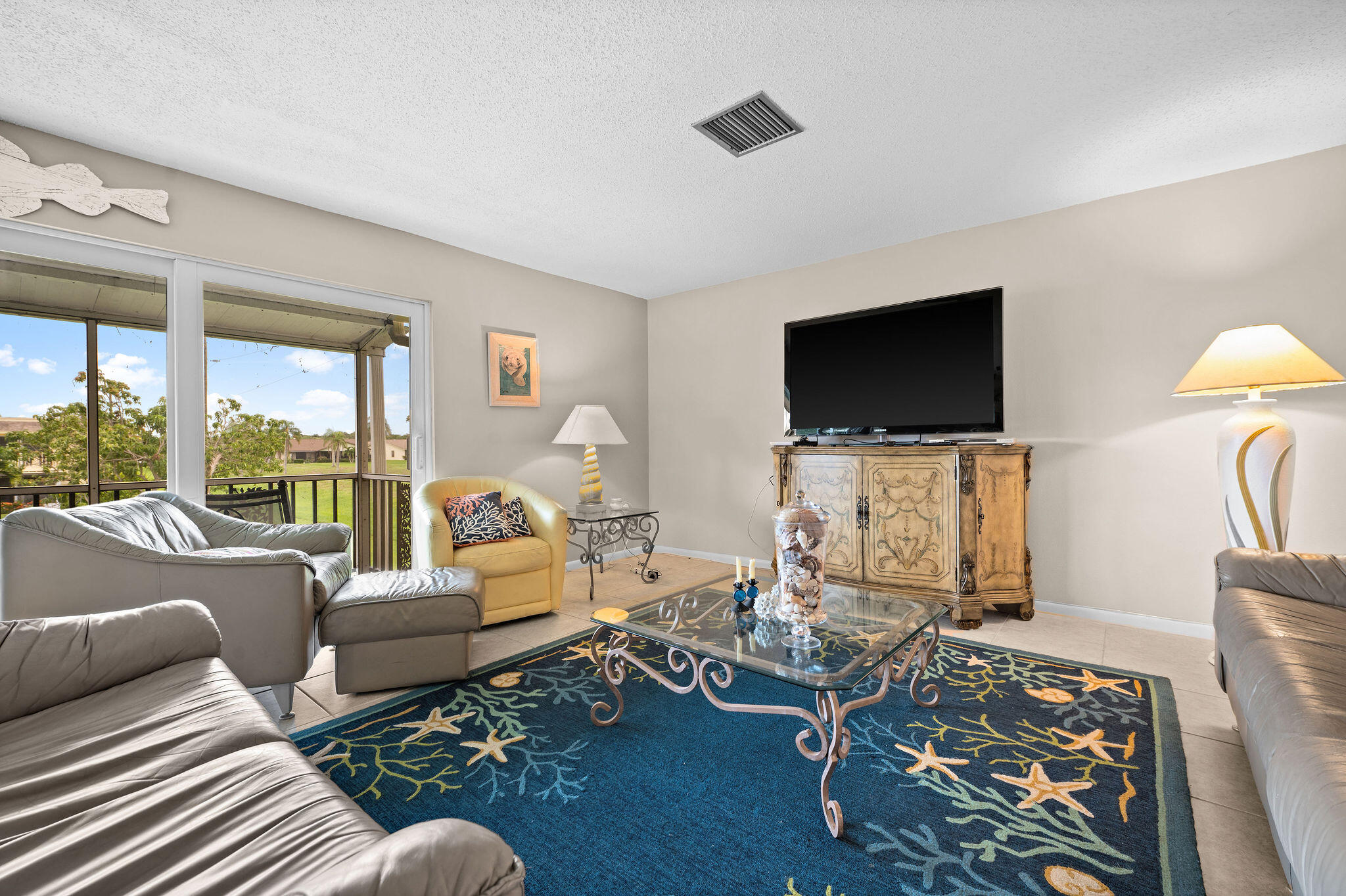 355 Palm Drive, Unit 2 Naples, FL 34112 - Photo 9 of 30 a living room with furniture and a flat screen tv