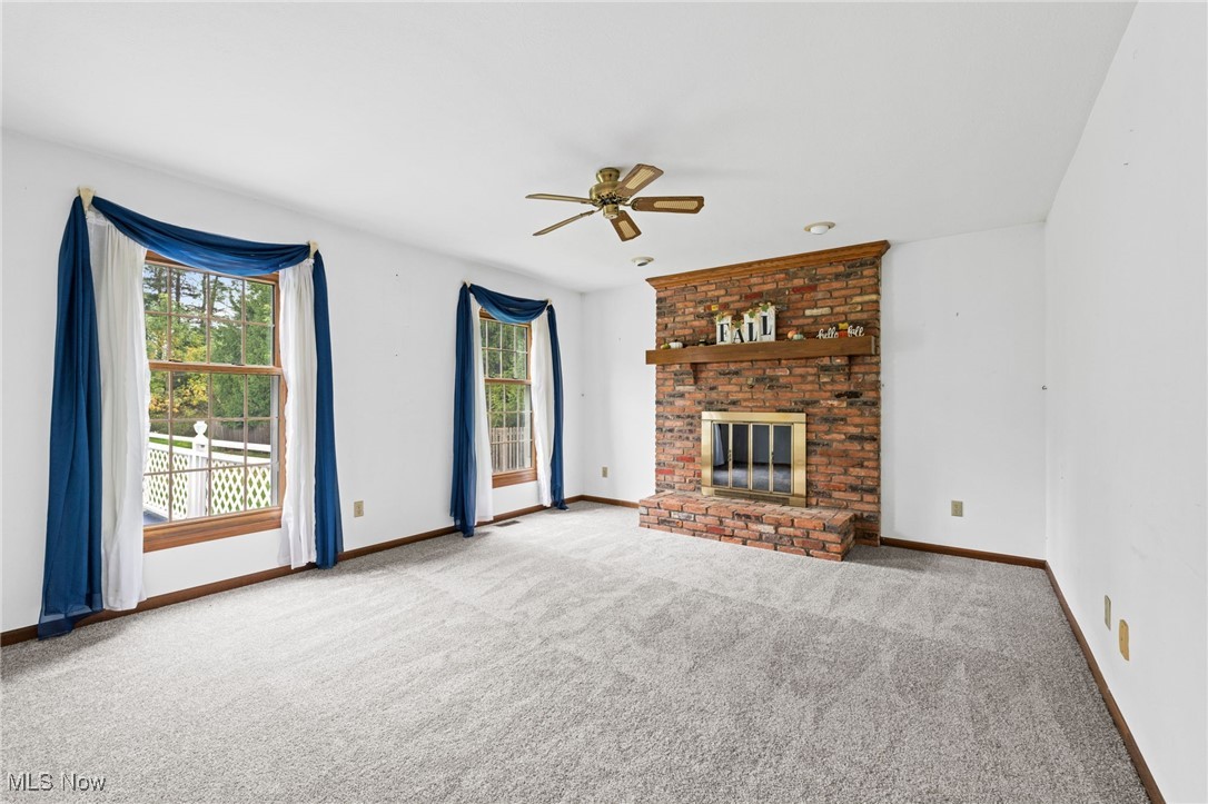 31655 Arthur Road Solon, OH 44139 - Photo 11 of 27 Living Room with natural, a brick fireplace, and ceiling fan