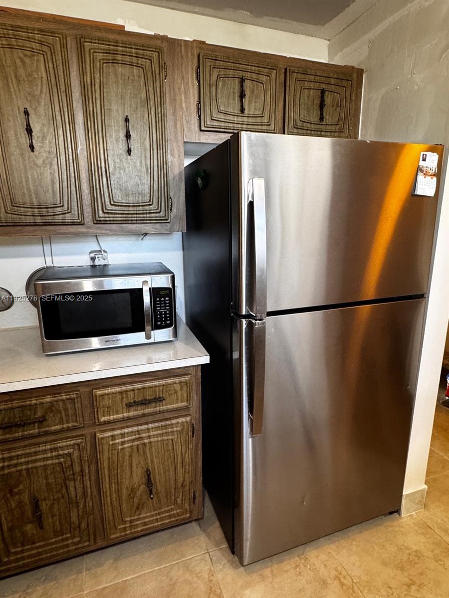 3671 Environ Boulevard, Unit 369 Lauderhill, FL 33319 - Photo 13 of 21 a kitchen with a refrigerator and a stove