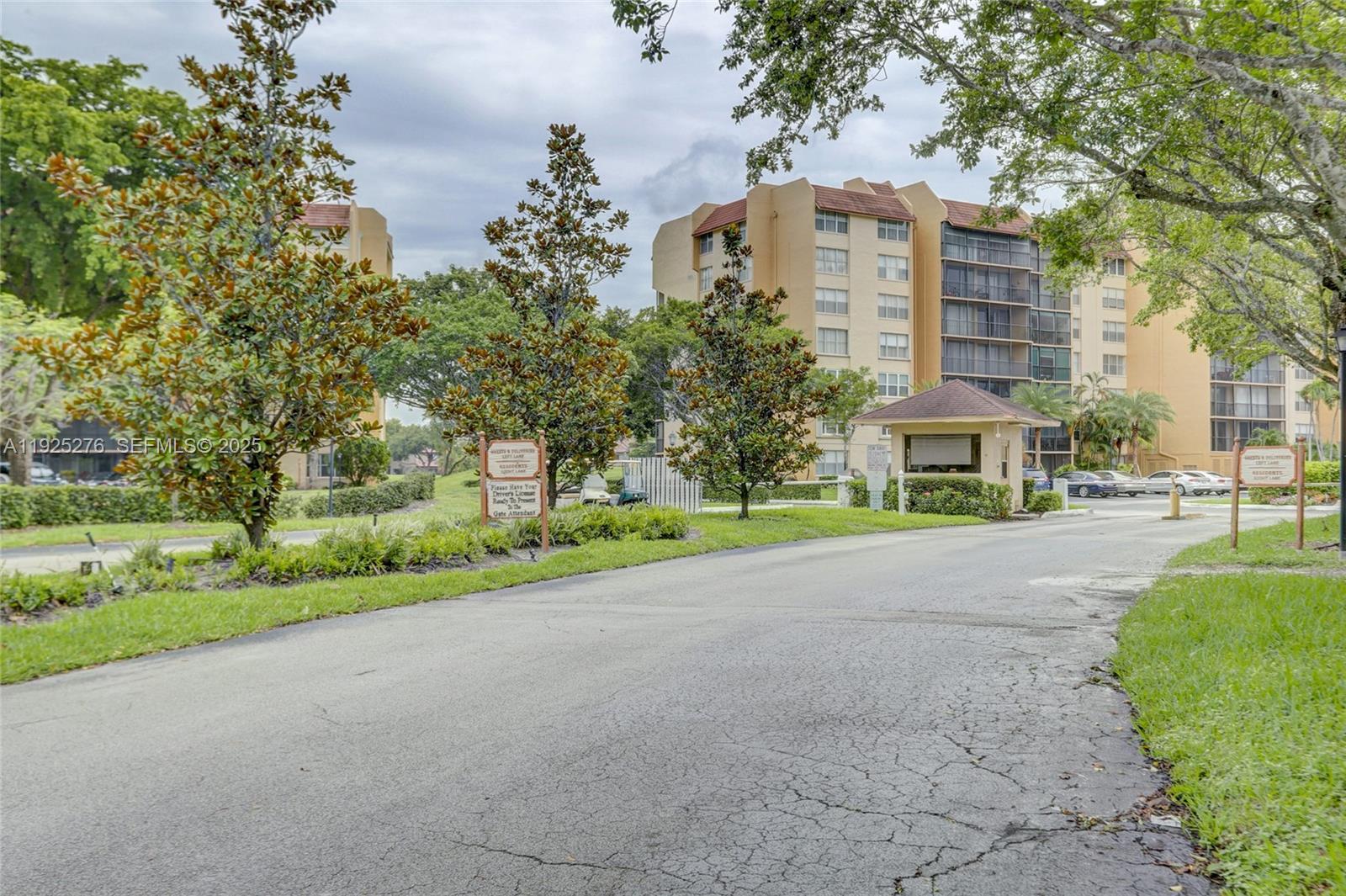 3671 Environ Boulevard, Unit 369 Lauderhill, FL 33319 - Photo 16 of 21 a front view of a house with a yard and garage