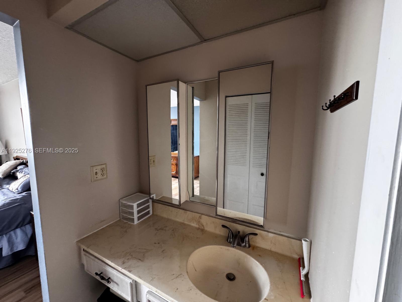 3671 Environ Boulevard, Unit 369 Lauderhill, FL 33319 - Photo 10 of 21 a bathroom with a sink and a mirror