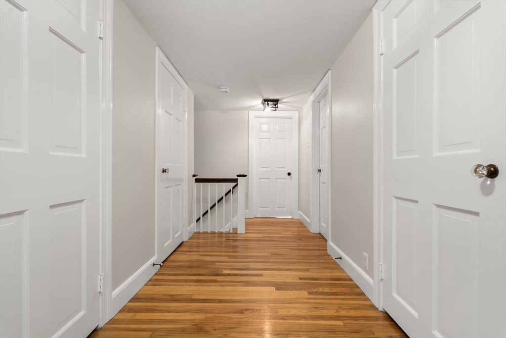 92 Abbot Street Andover, MA 01810 - Photo 27 of 35 a view of a hallway with wooden floor and staircase