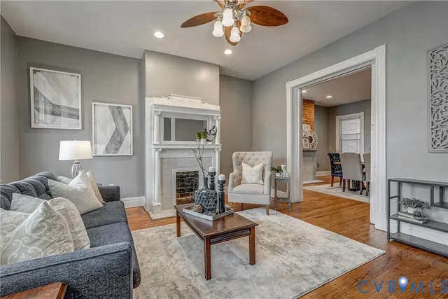 a living room with furniture a fireplace and a table