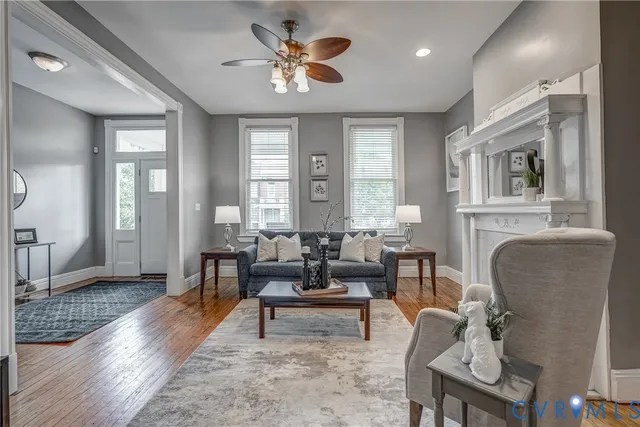 a view of a a dining room with furniture window and wooden floor