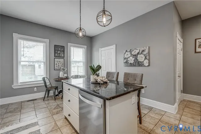 a living room with wooden floor and a potted plant