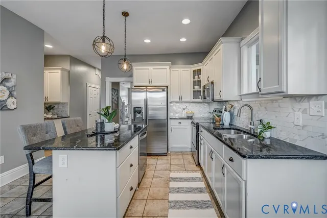 a bathroom with a toilet a sink a vanity a mirror and window