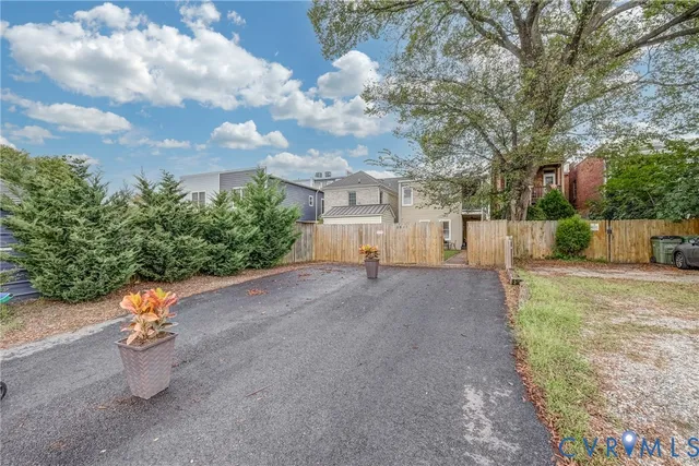 a view of an empty room with a fireplace and a window