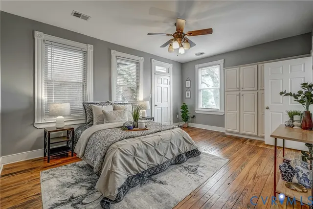 a view of empty room with fireplace and wooden floor