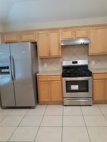 a kitchen with appliances and cabinets