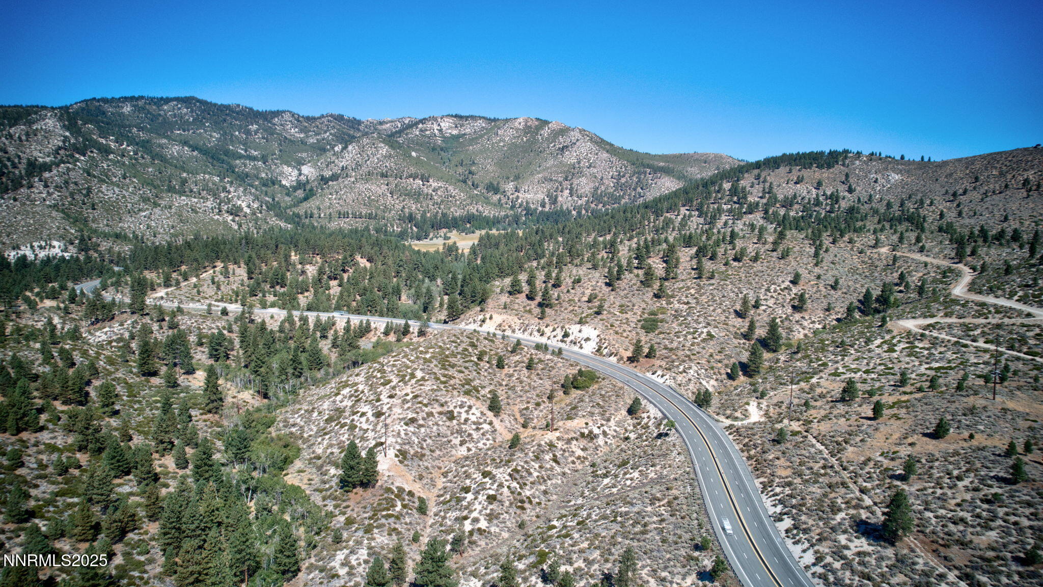 5645 Highway 50 Carson City, NV 89705 - Photo 5 of 11 a view of a forest with mountains in the background