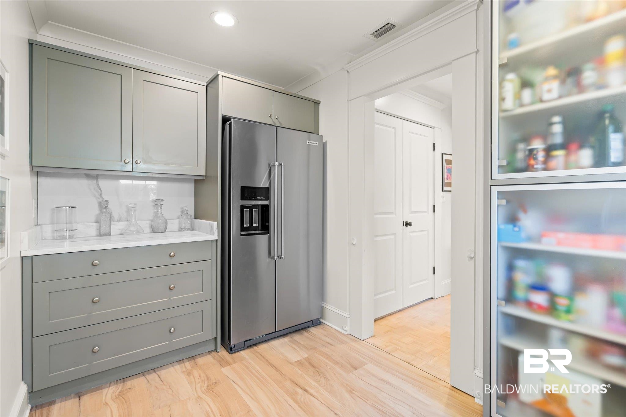 3921 McGregor Court Mobile, AL 36608 - Photo 13 of 41 Kitchen with visible vents, gray cabinetry, light countertops, light wood-style floors, and high end refrigerator