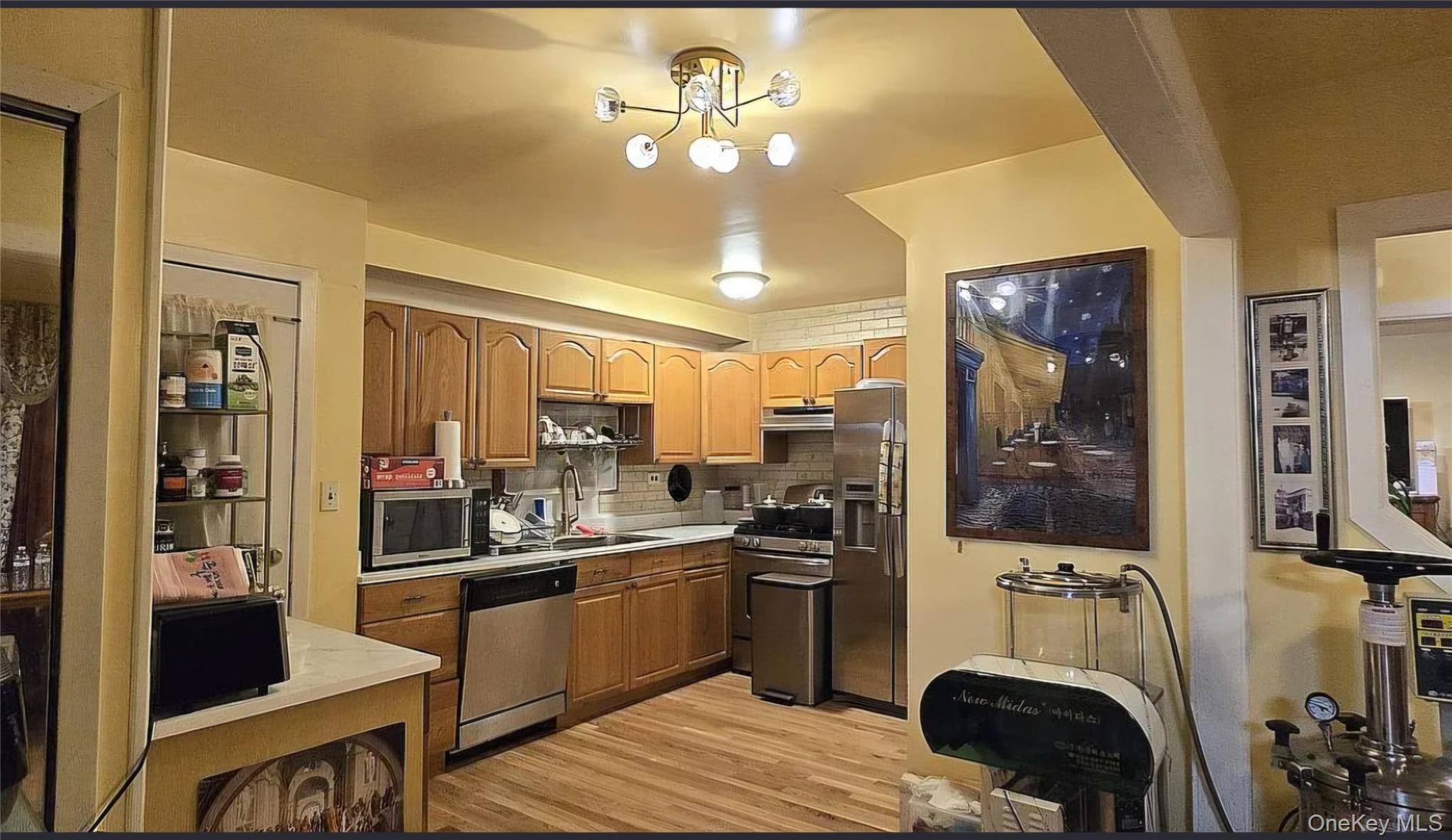 257 Schenck Avenue Great Neck, NY 11021 - Photo 5 of 9 a kitchen with a sink appliances and cabinets