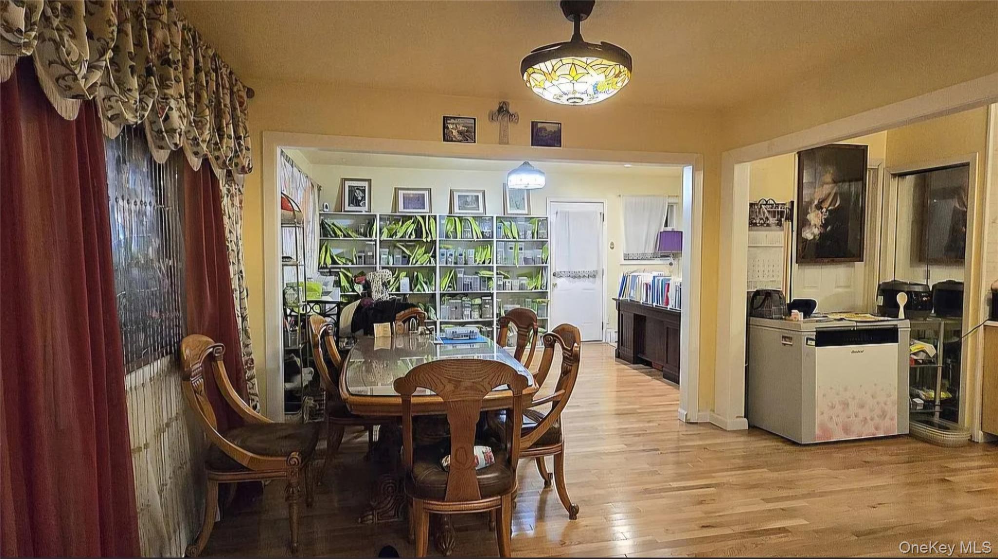 257 Schenck Avenue Great Neck, NY 11021 - Photo 6 of 9 a view of a dining room with furniture window and wooden floor
