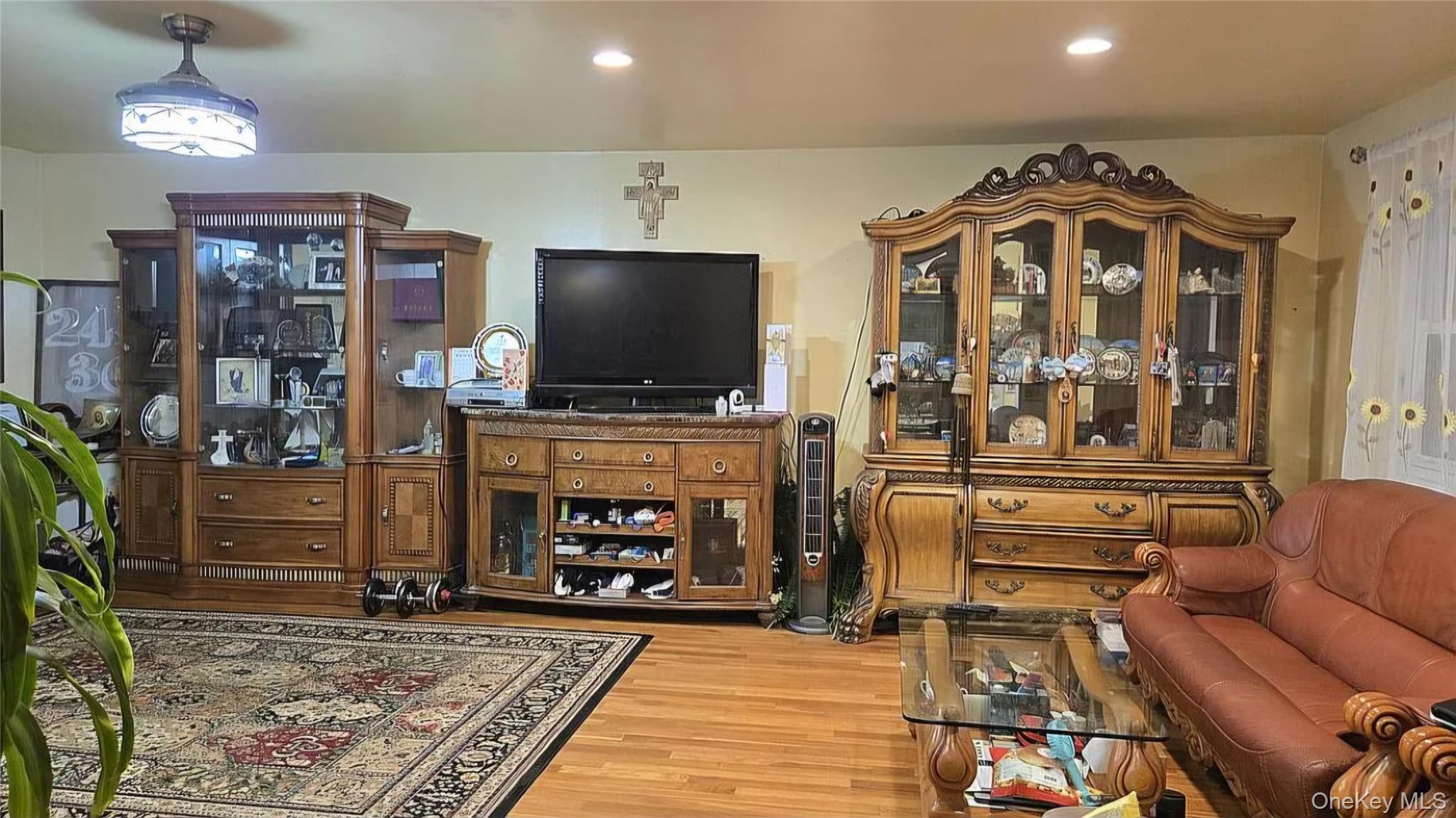 257 Schenck Avenue Great Neck, NY 11021 - Photo 7 of 9 a living room with furniture and a flat screen tv
