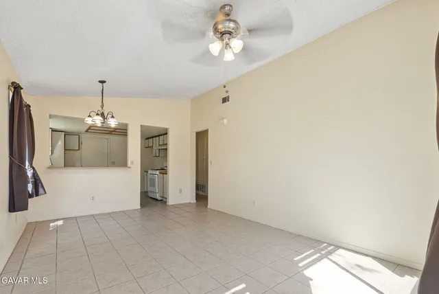 a view of a kitchen with a sink and a chandelier