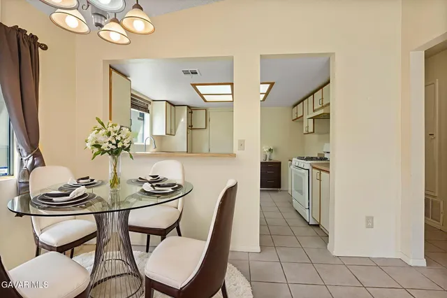 a dining room with furniture and a chandelier